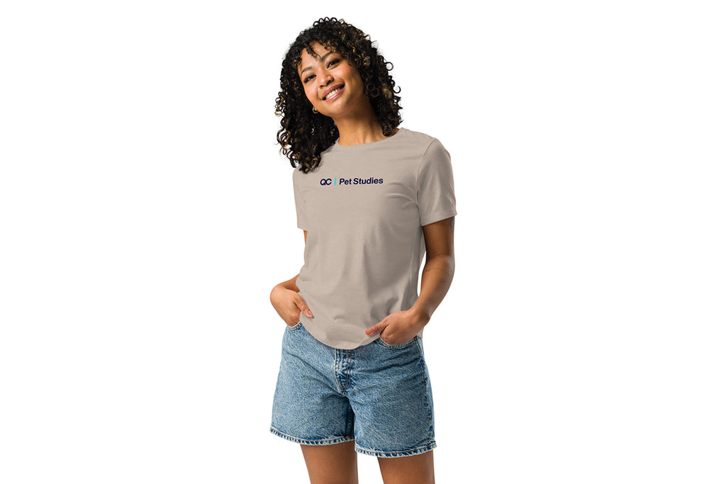 Woman wearing a beige t-shirt with a QC Pet Studies logo on a white background