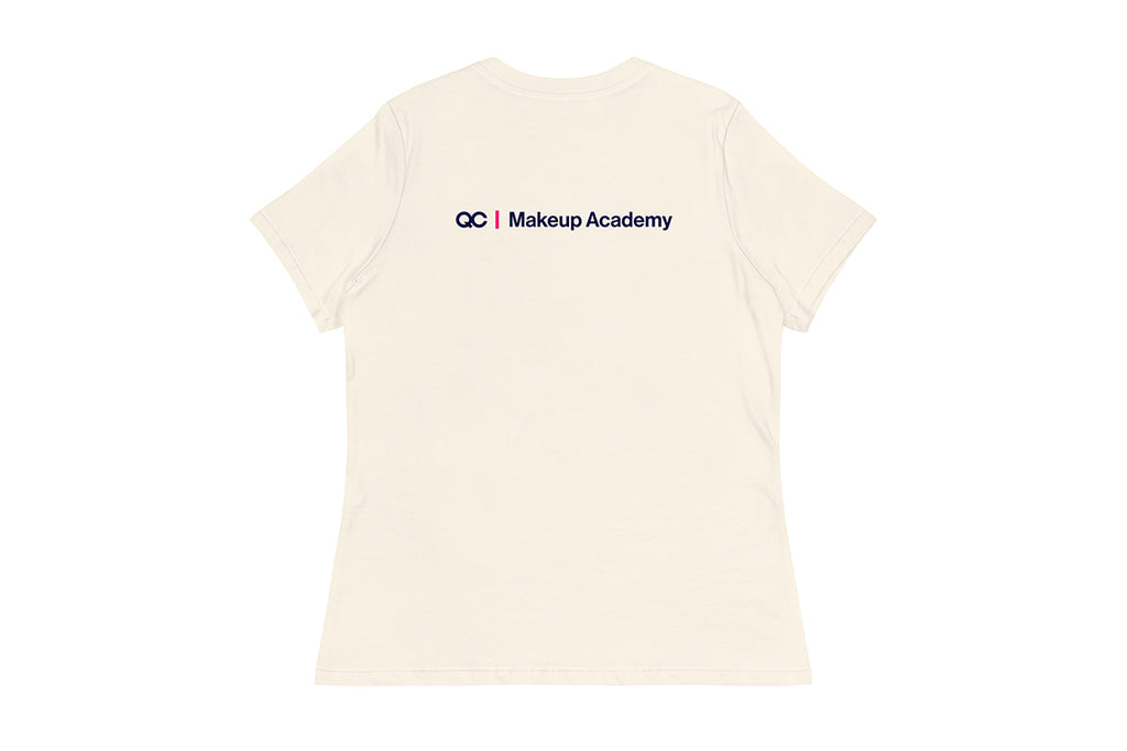 Back of beige t-shirt with 'QC Makeup Academy' text on a white background