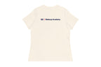 Back of Beige t-shirt with 'QC Makeup Academy' text on a white background