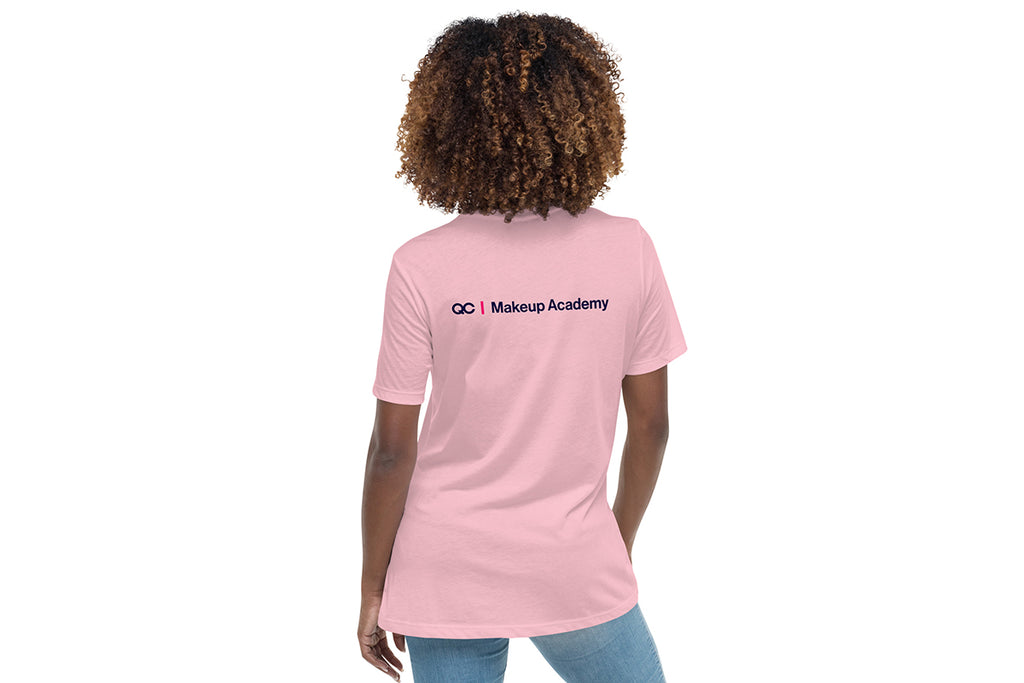 Person wearing a pink t-shirt with 'QC Makeup Academy' text on the back against a white background