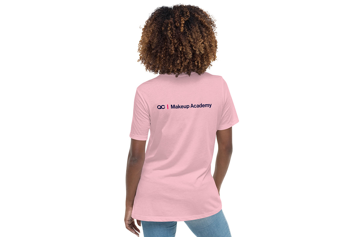 Person wearing a pink t-shirt with 'QC Makeup Academy' text on the back against a white background