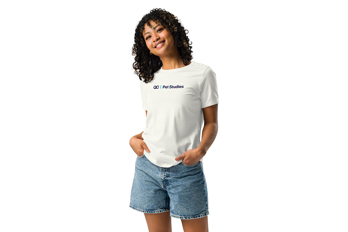 Person wearing a off-white t-shirt with a QC Pet Studies logo on a white background
