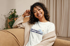 Woman wearing a 'Mid-Century Modern Mindset' shirt sitting on a couch.