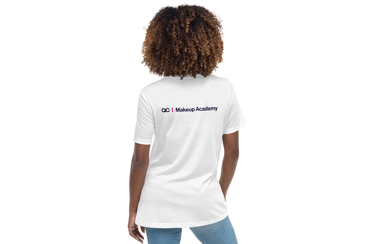Person wearing a white t-shirt with 'QC Makeup Academy' text on the back against a white background